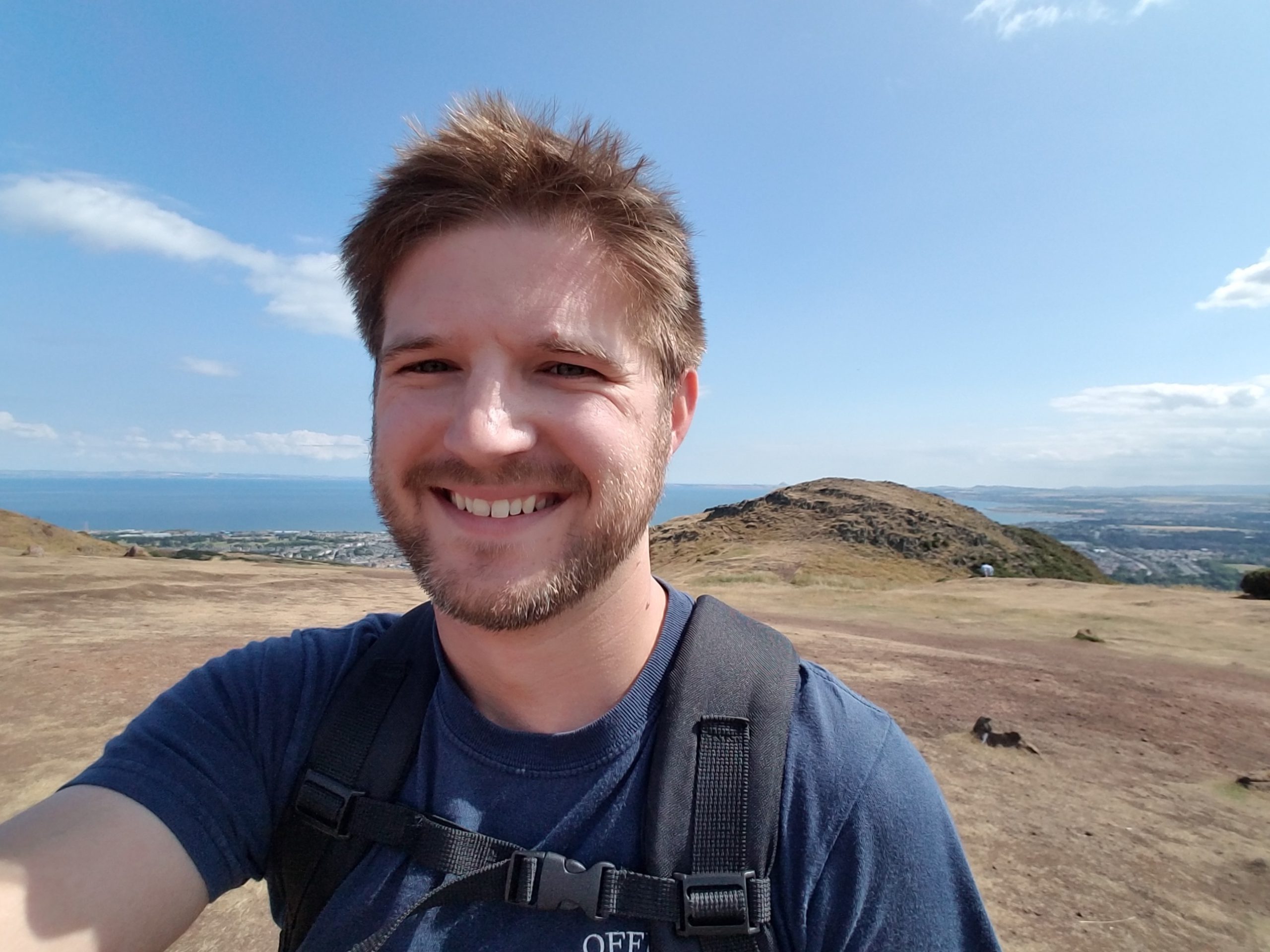 Picture of the author standing near Arthur&rsquo;s Seat in Edinburgh